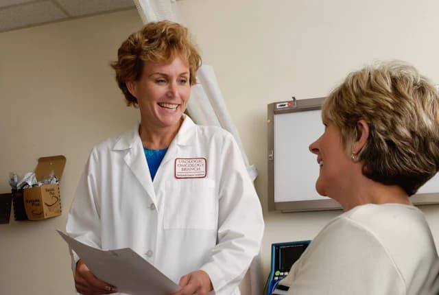 Clinician discussing a care plan document with a patient.