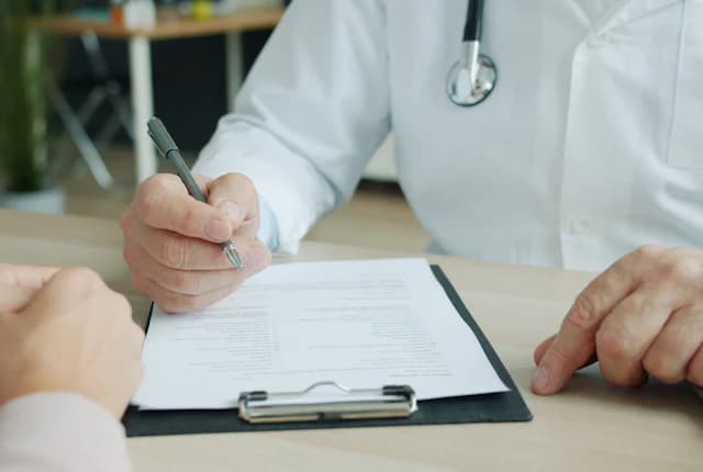 Clinician reviewing registration paperwork with a patient.